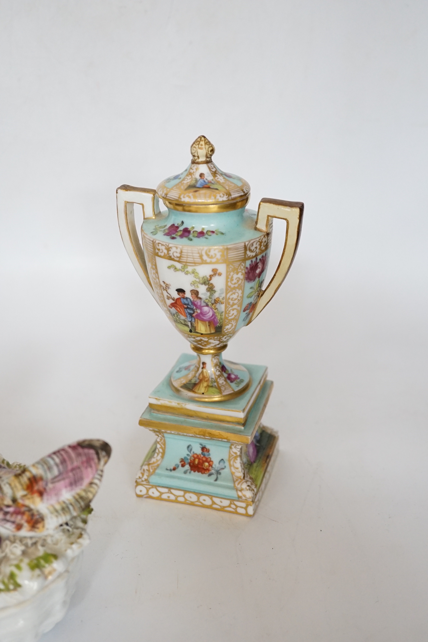 A pair of Dresden porcelain vases and covers (restored) together with a hen egg basket and cover, largest 19cm high (3)